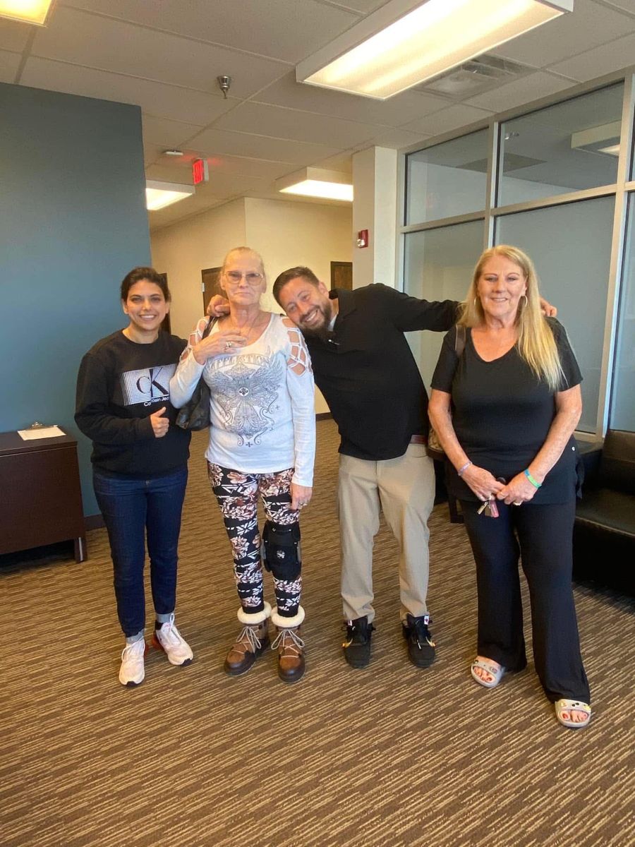 The Real Hope team with two homeowners in an office lobby